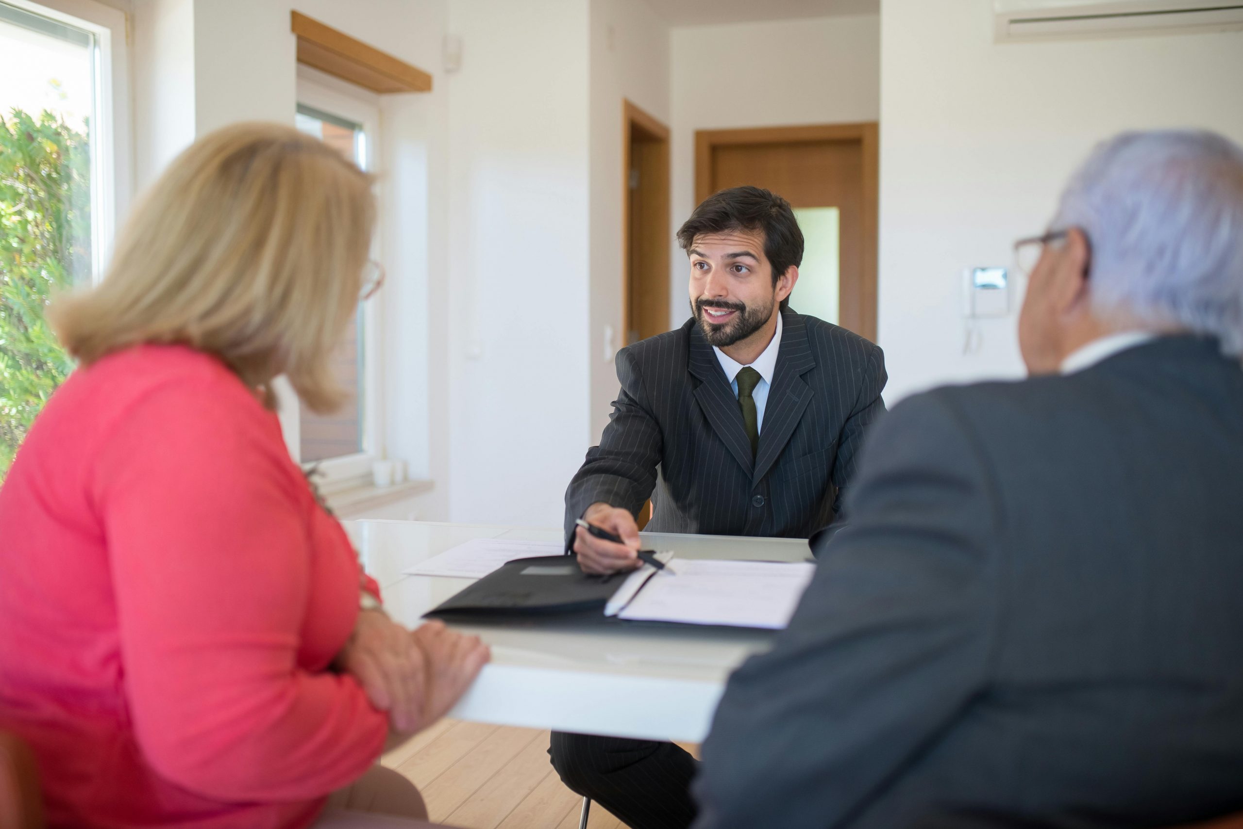 A real estate agent discussing property details with clients, showcasing opportunities for real estate careers and realtor jobs near me.