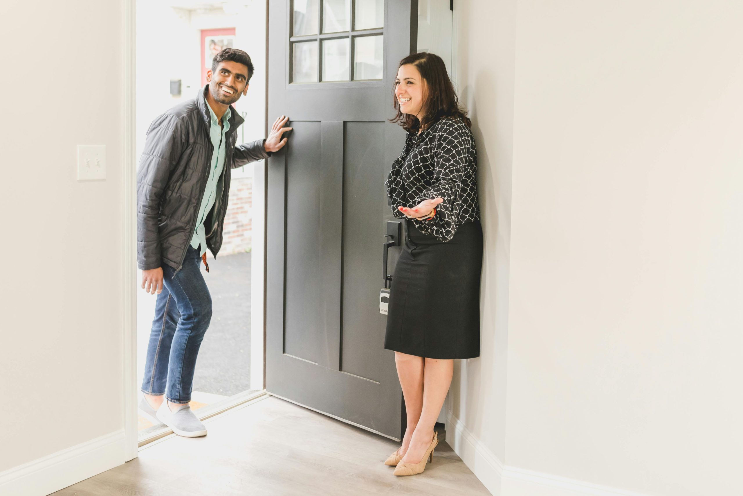 Real estate agent opening a door